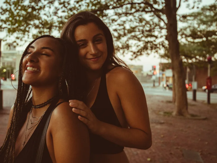 Two people outdoors, close and at ease together